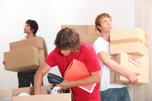 Professional movers handling office equipment